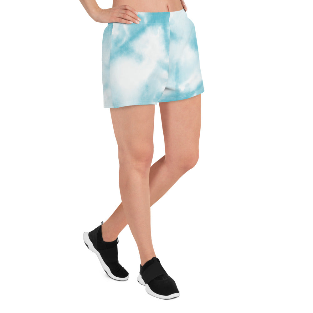 Blue tie dye womens shorts trunks on female model with an angled side view