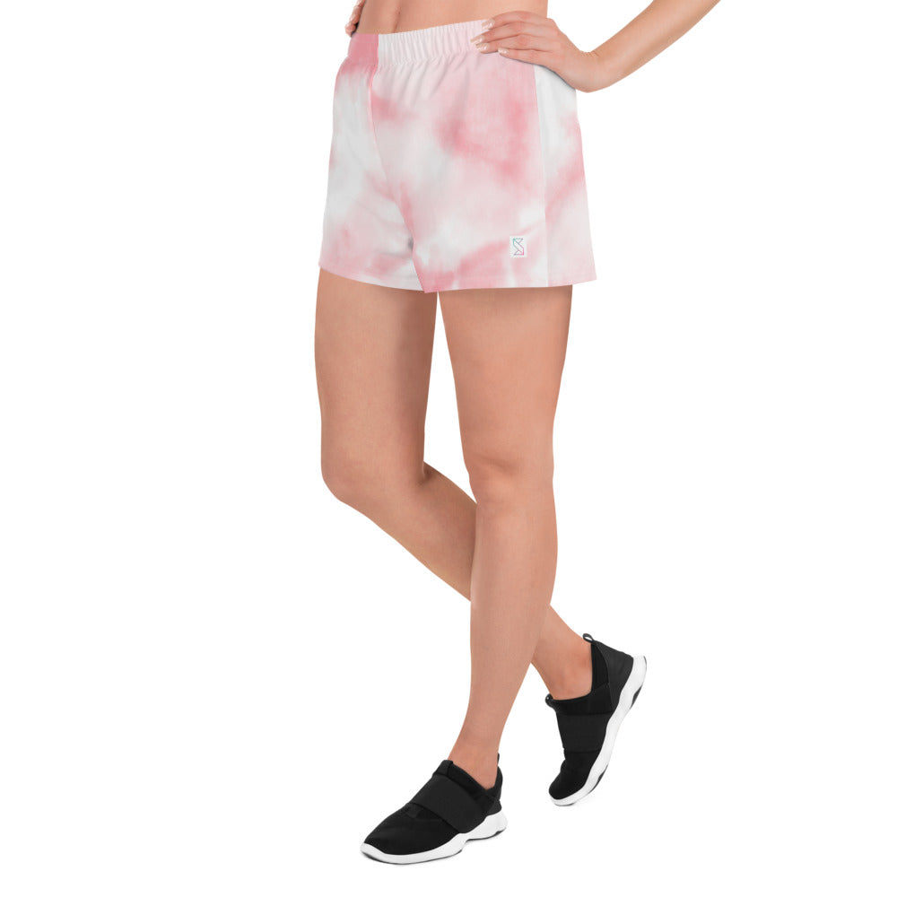 Pink tie dye womens shorts trunks on female model with a front view