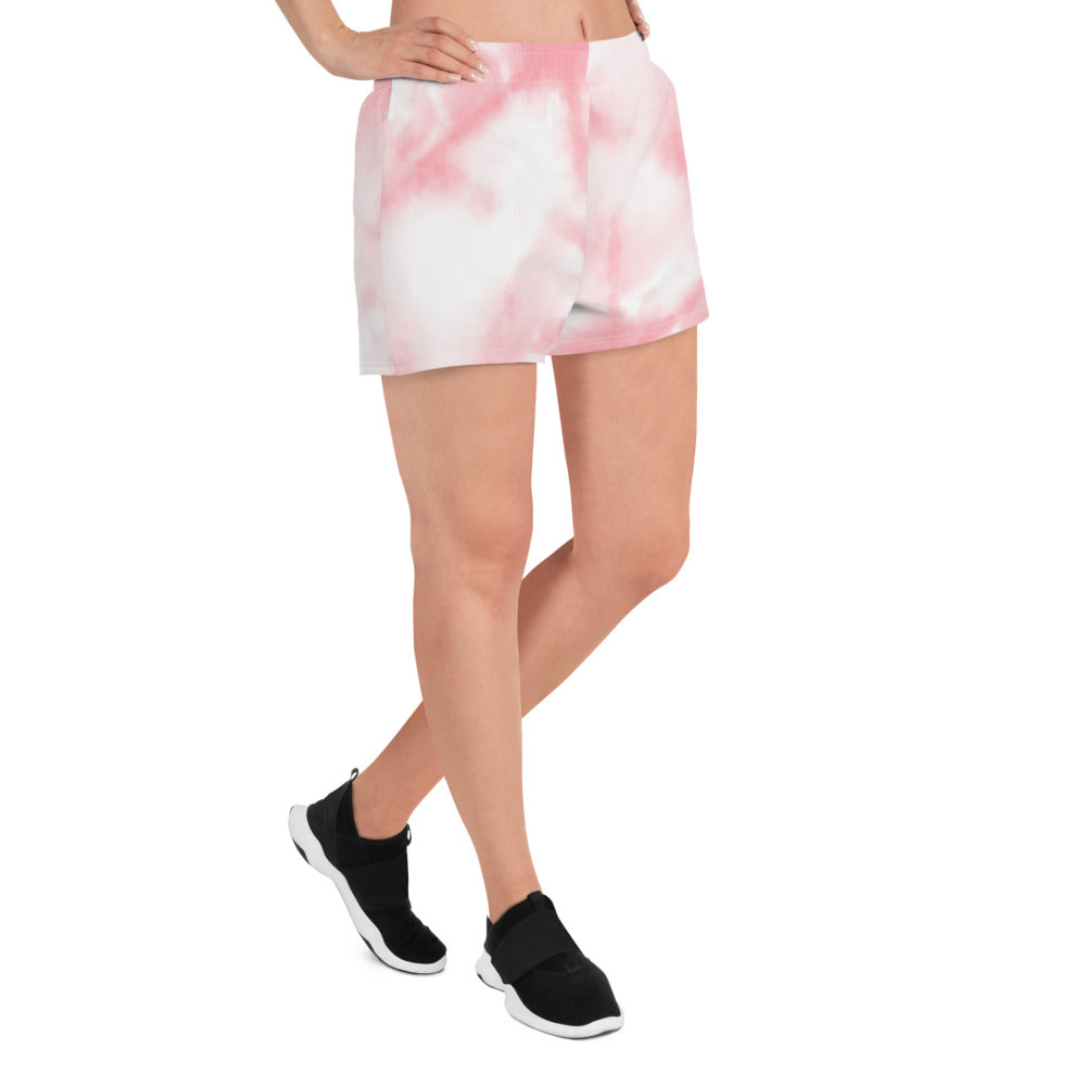 Pink tie dye womens shorts trunks on female model with an angled side view